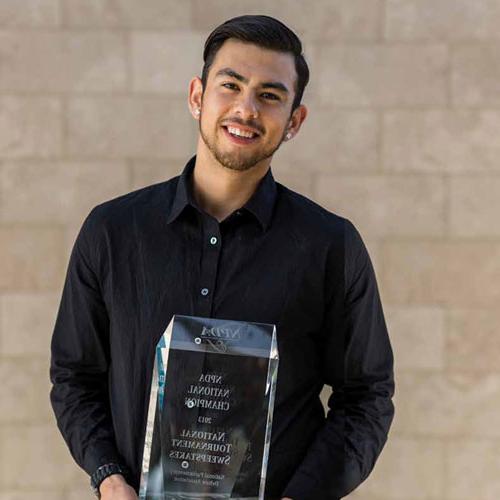 Diego Perez standing with trophy