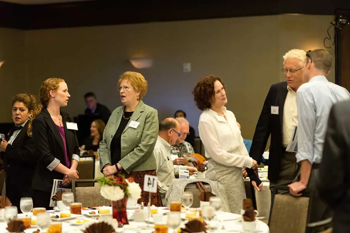 Attendees talking before the event