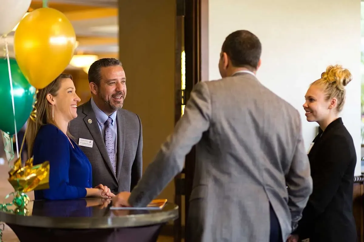 Attendees talking before the event