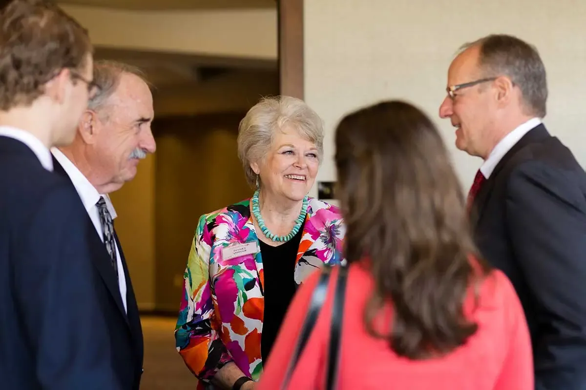 Attendees talking before the event